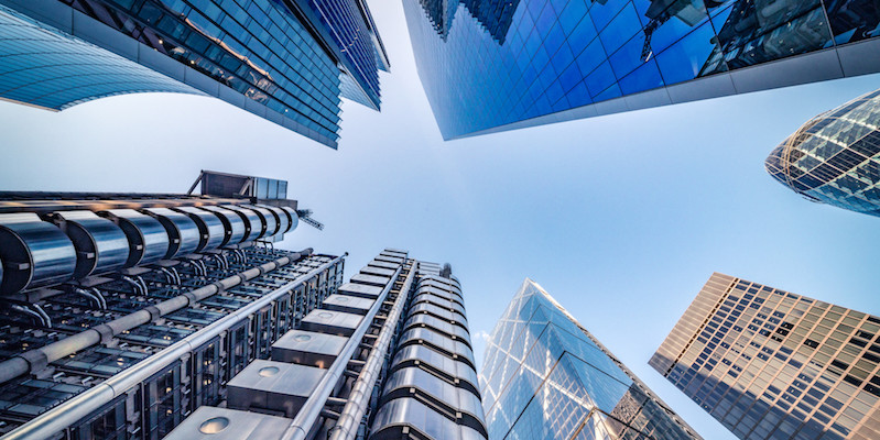 Looking directly up at the skyline of the financial district in central London - stock image
