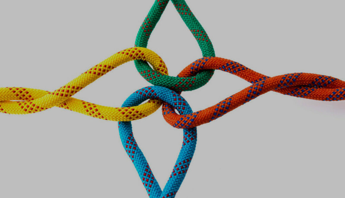 Colored ropes tied on white background